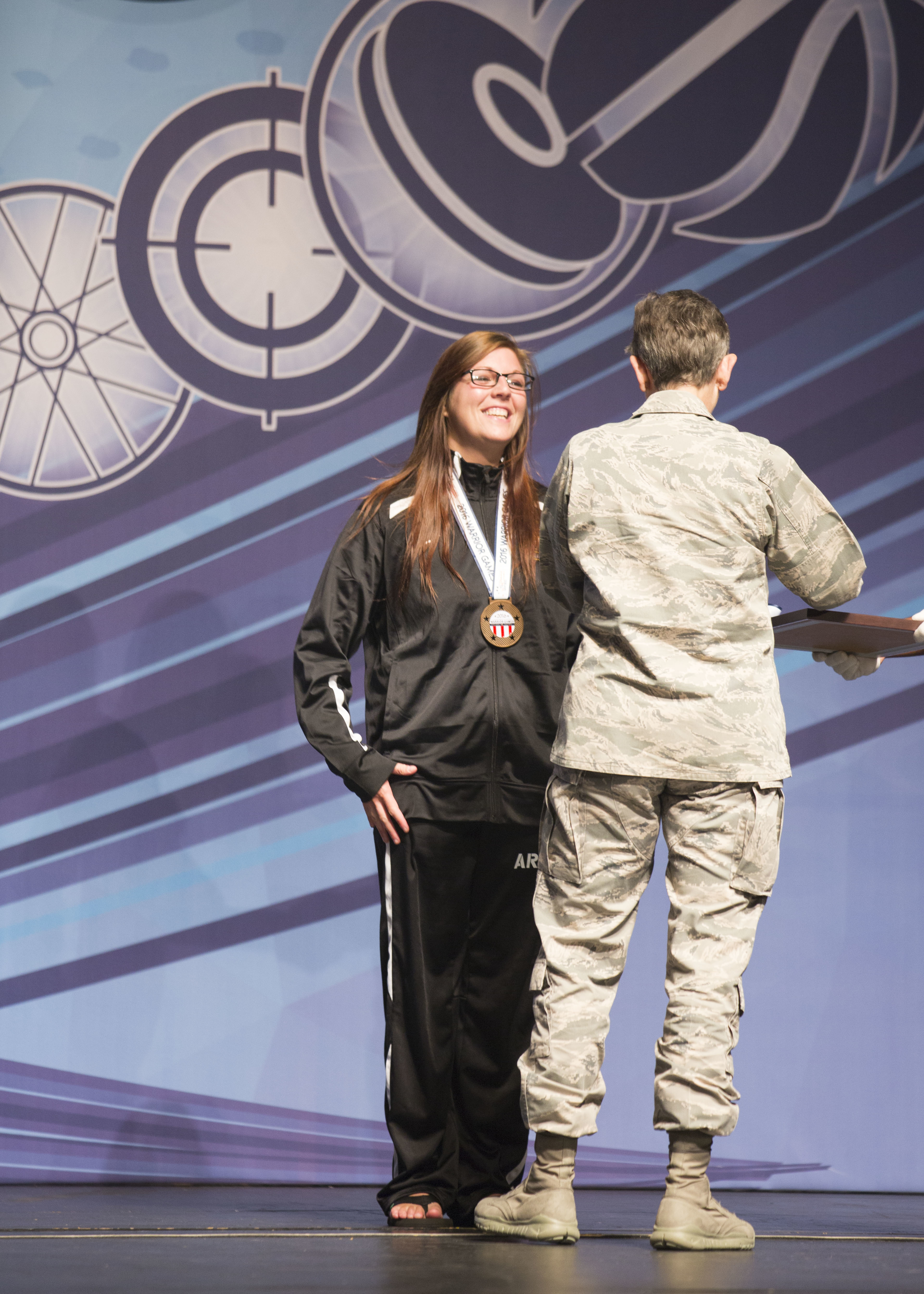 U.S. Army Staff Sgt. Ashley Anderson, assigned to Warrior Transition Battalion, Fort Riley, Kansas, receive a bronze medal for the women's fifty yard freestyle swimming category, 2016 Department of Defense Warrior Games 