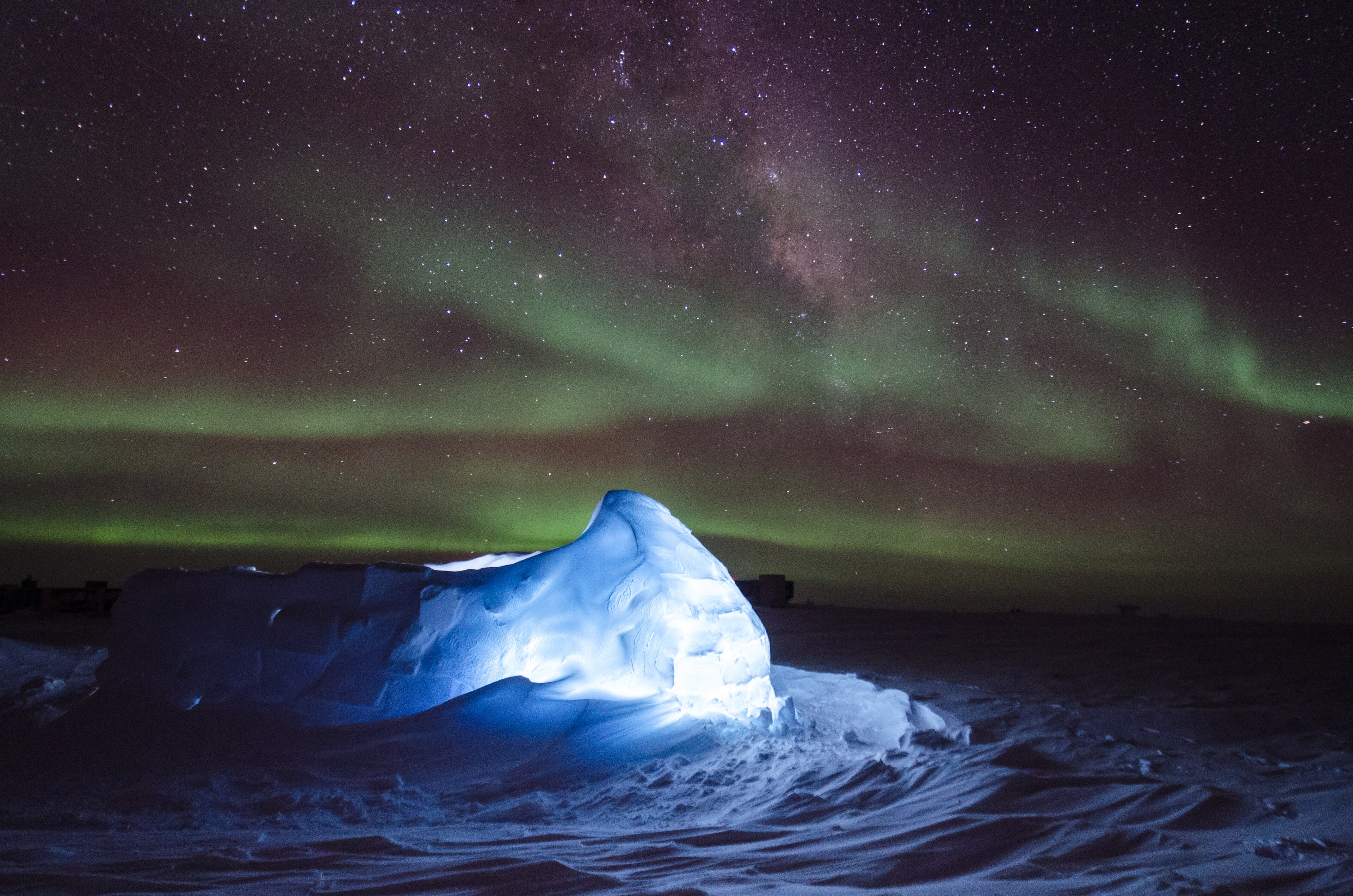 Aurora australis dancing over an LED illuminated igloo giving a blue tinge to the color of snow.  
 Image ID: anta0159, NOAA At The Ends of the Earth Collection 
Photo Date: 2013 austral winter 
 
Photographer: Ross Burg