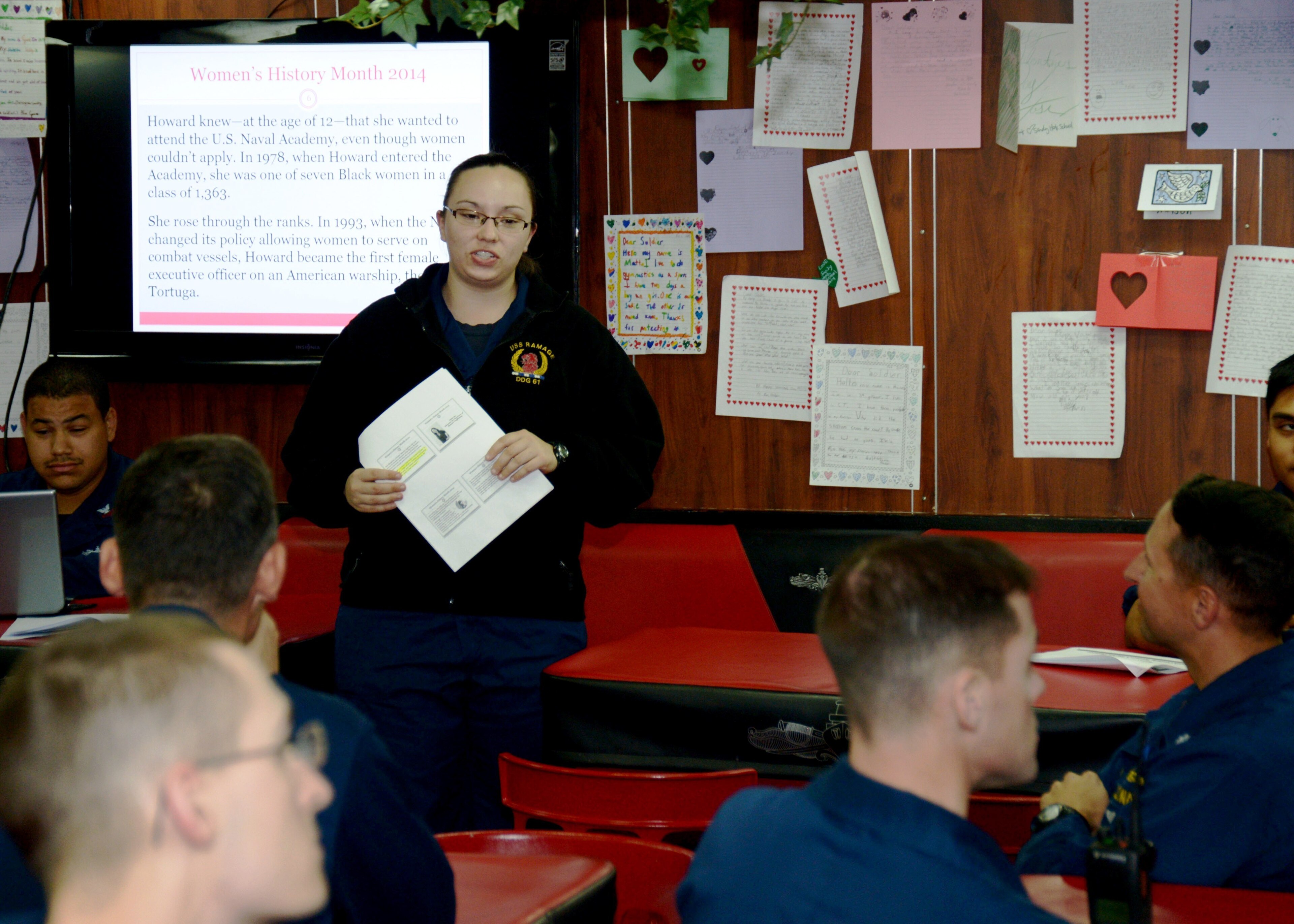 Ensign Brittney White, assigned to the guided-missile destroyer USS Ramage, gives a presentation on the mess decks to celebrate women’s history month. Ramage, homeported in Norfolk, Va., is on a scheduled deployment supp