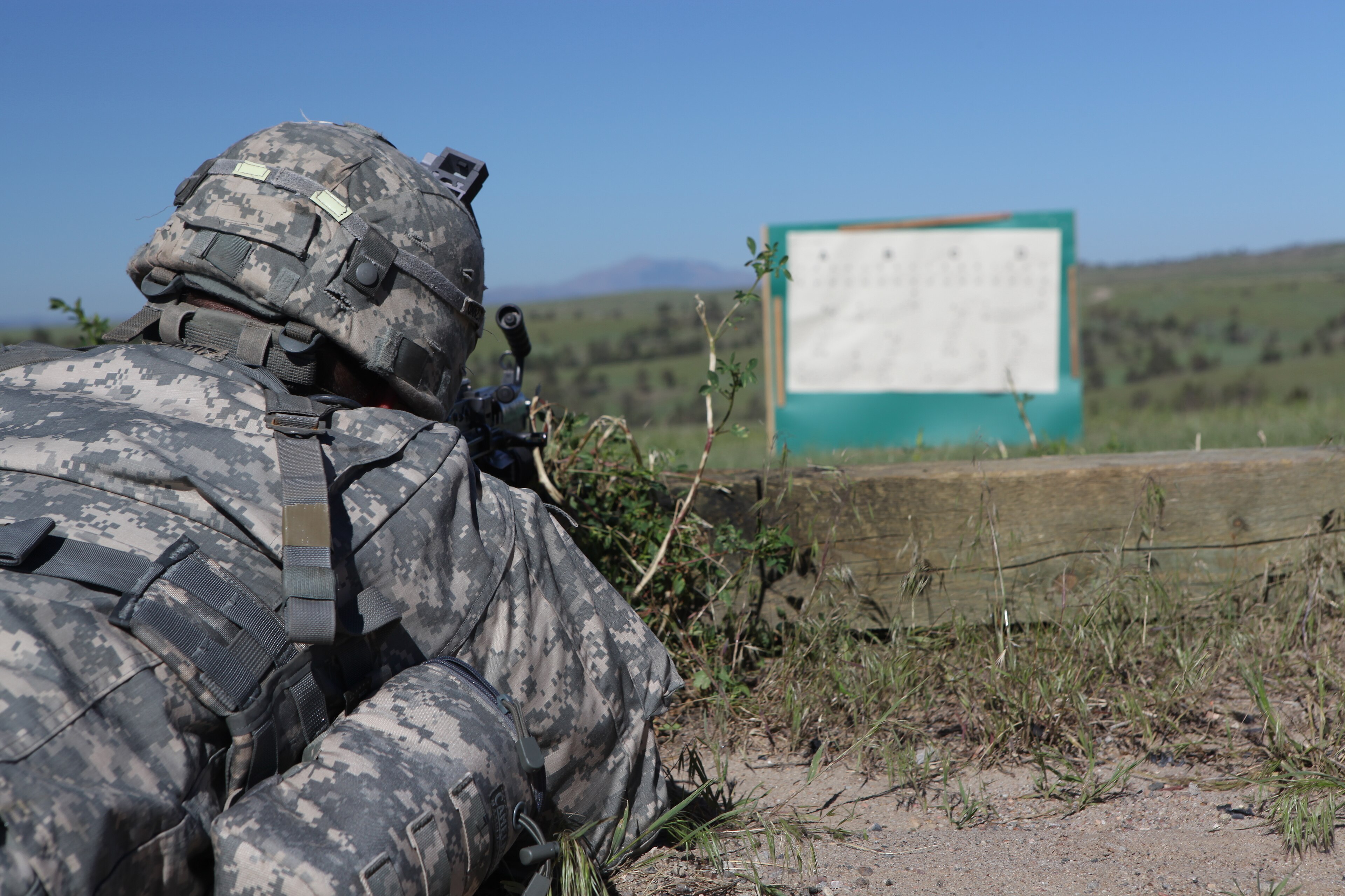 U.S. Army National Guard Spc. Christin Ramos from Alpha Company 1st Battalion 143rd (Airborne) Infantry Regiment zeros a 249 squad automatic machine gun at the 60/10 meter range on Camp Guernsey, Guernsey, Wyo., during t