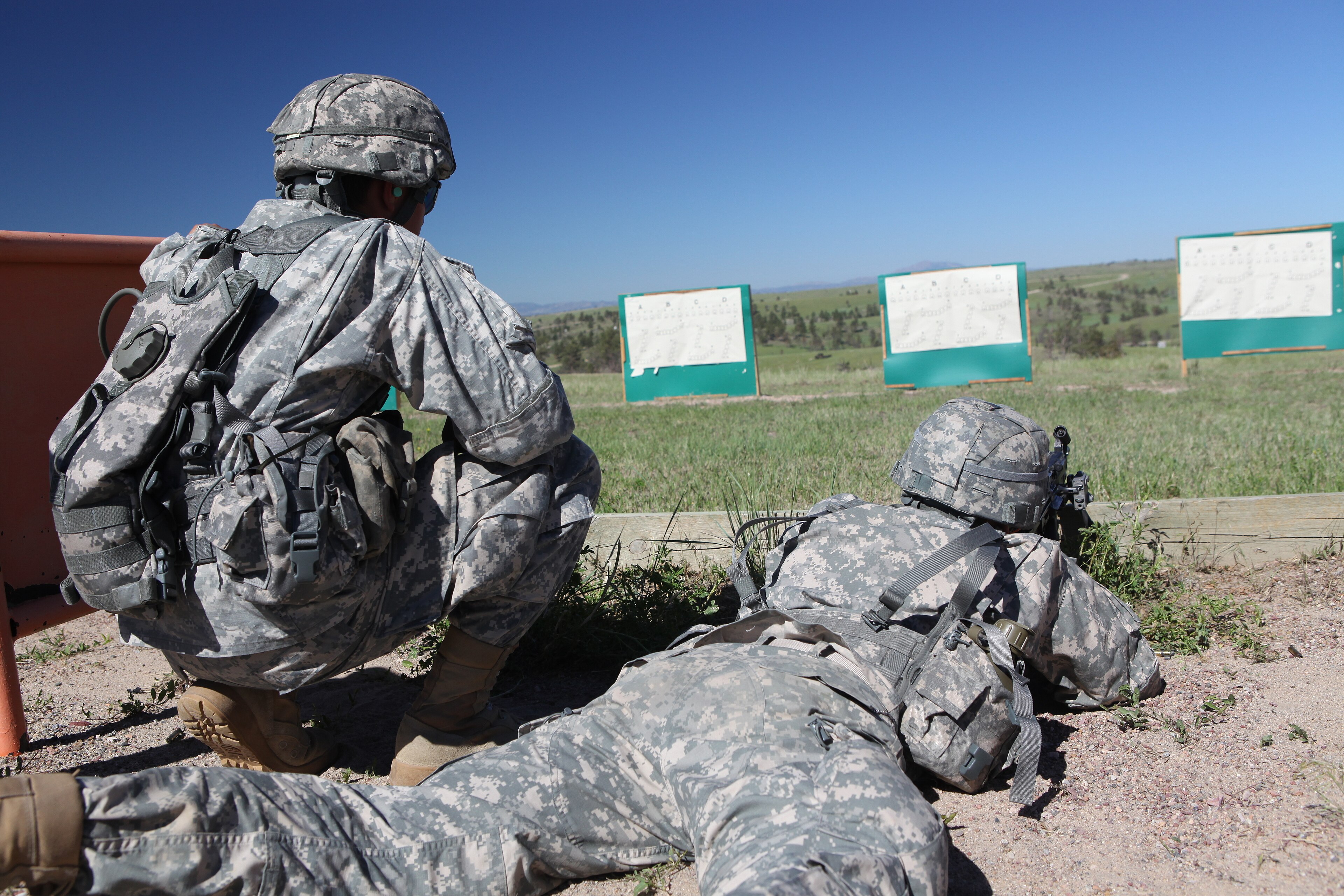 U.S. Army National Guard Spc. Aaron Aguilar and Spc. Christin Ramos from Alpha Company 1st Battalion 143rd (Airborne) Infantry Regiment zero a 249 squad automatic weapon at the 60/10 meter range on Camp Guernsey, Guernse