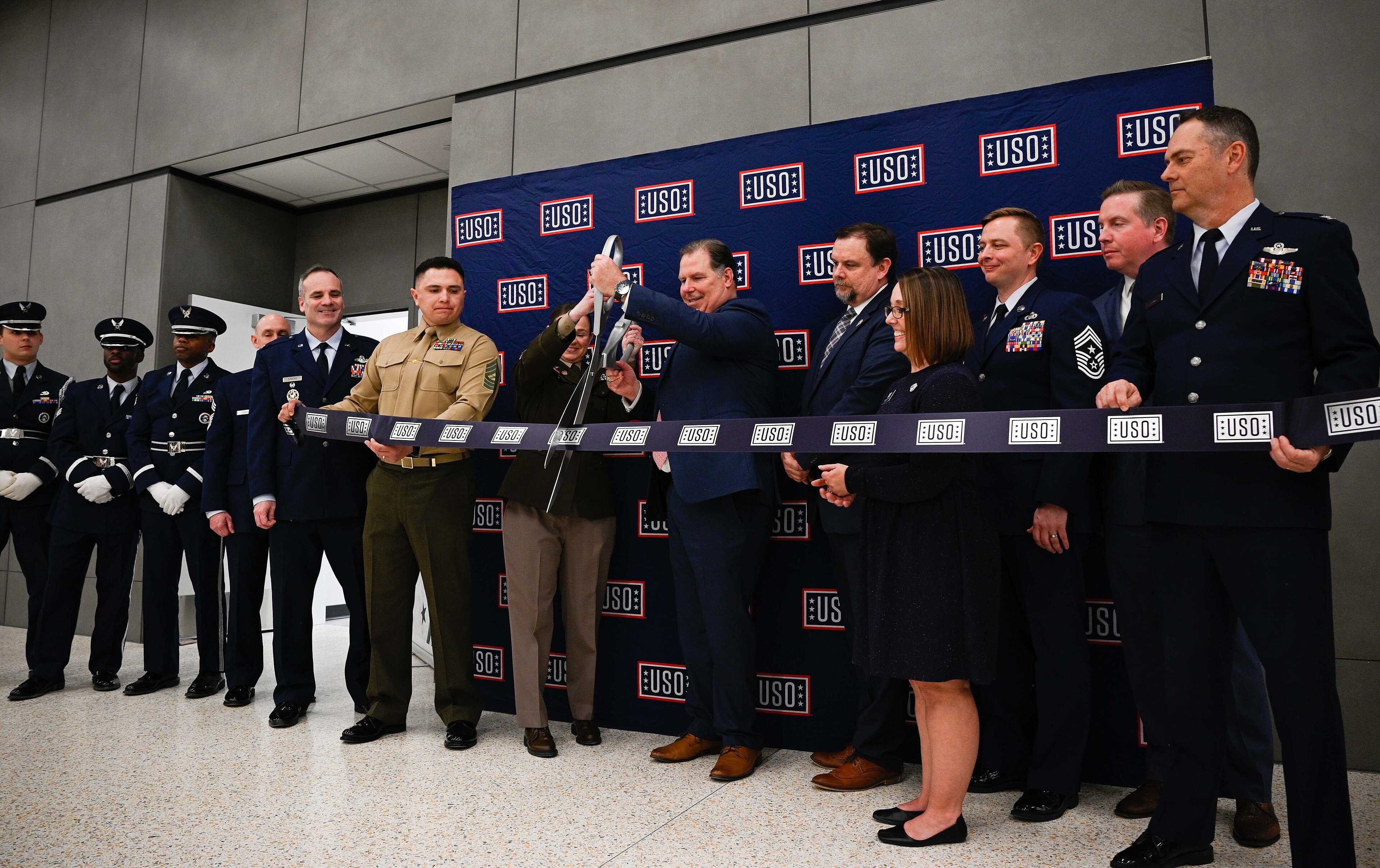 Whiteman Air Force Base leadership and Honor Guard Airmen participate in the United Service Organizations Inc. ribbon-cutting ceremony at the new terminal in the Kansas City International Airport in Kansas City, Missouri