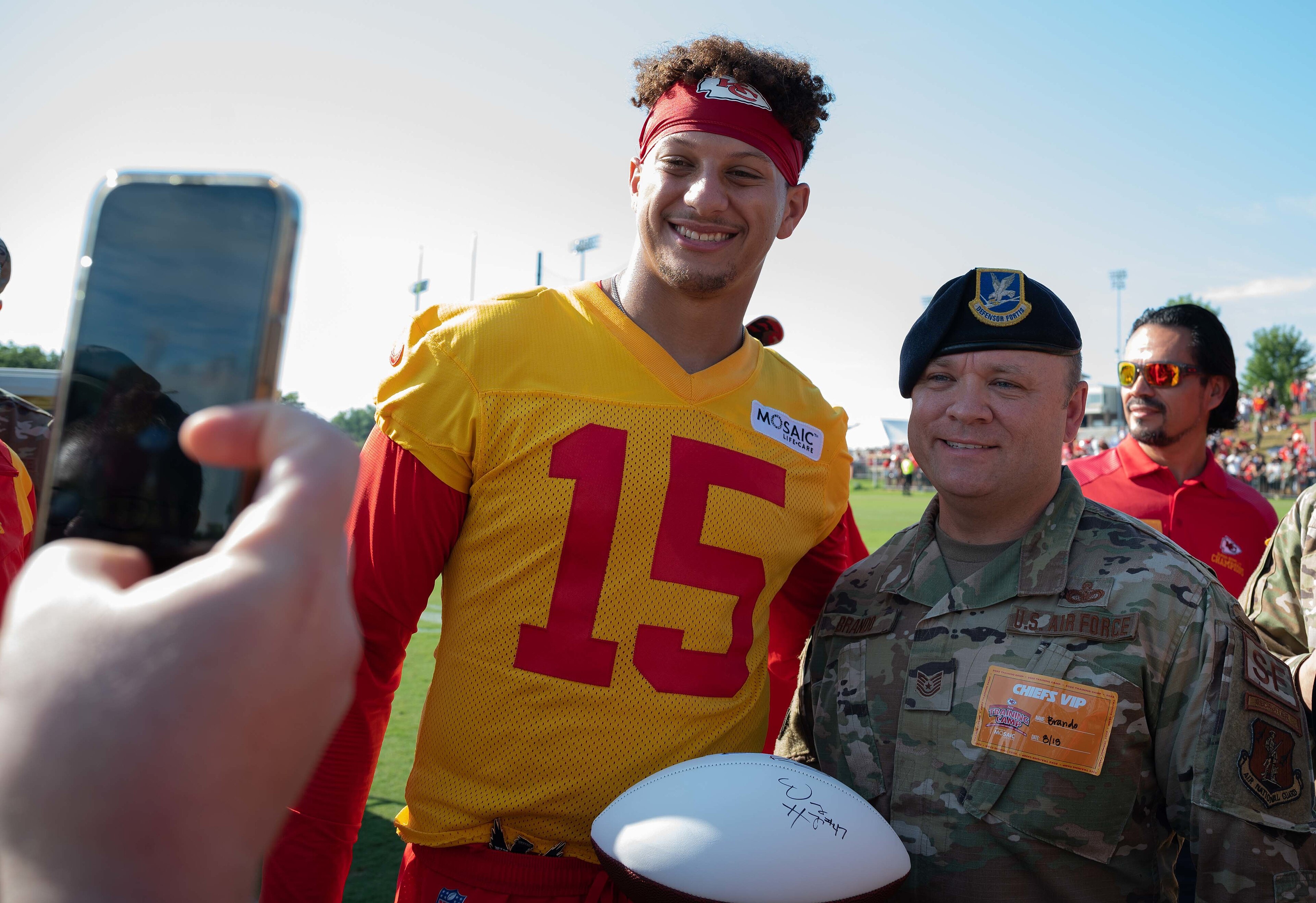 U.S. Air Force Tech Sgt. James Brando with the 139th Airlift Wing recruiting team takes a photo with Patrick Maholms, quarterback for the Kansas City Chiefs football team at the Chiefs Training Camp in St. Joseph, Missou