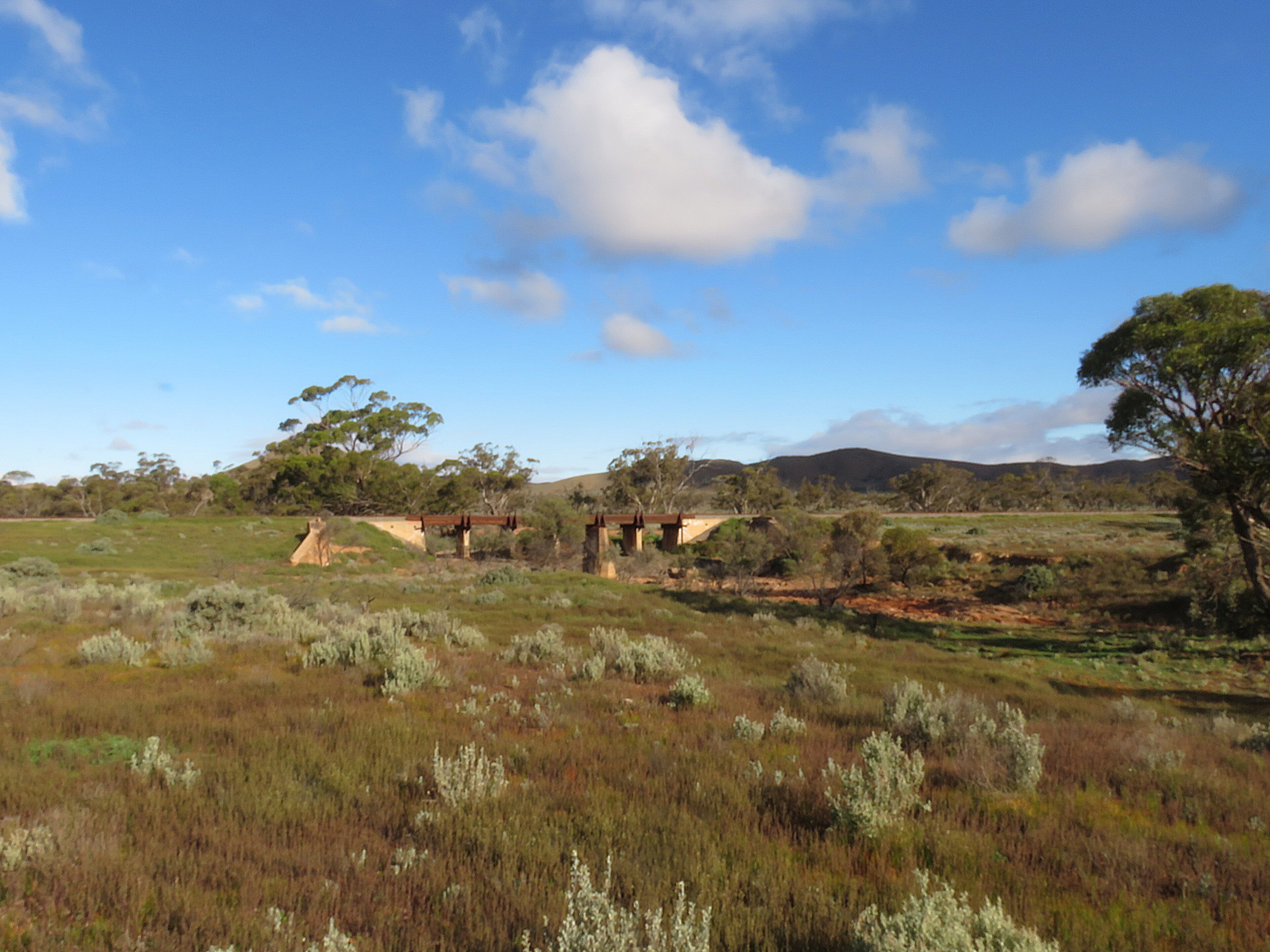 The Crystal Brook–Broken Hill railway line bridge over the Cavanagh Chase, South Australia. It is located west of Mannahill, in the locality of Winnininnie, near the tourist attraction of the Big Dice. The old railway br