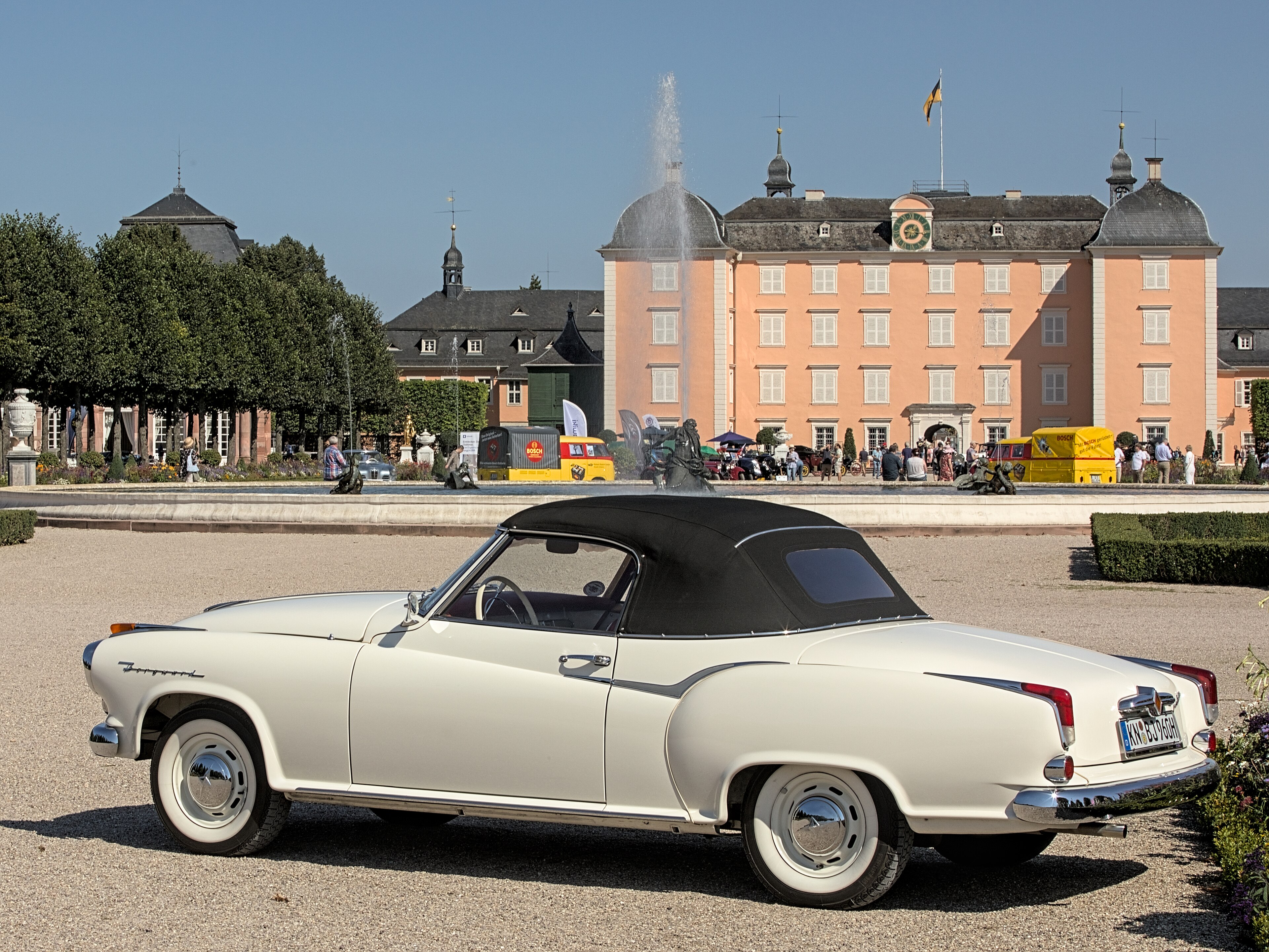A creme-colored Borgward Isabella Cabriolet at Classic-Gala 2021 (black top up) in front of Schloss Schwetzingen, Baden-Württemberg, Germany.