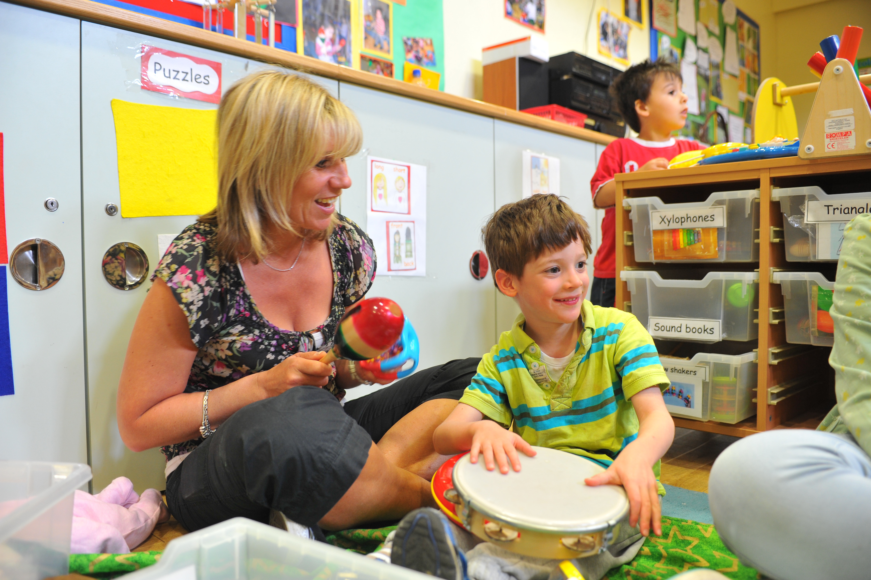 A staff member plays with a child at our Kennedy Leigh Centre.