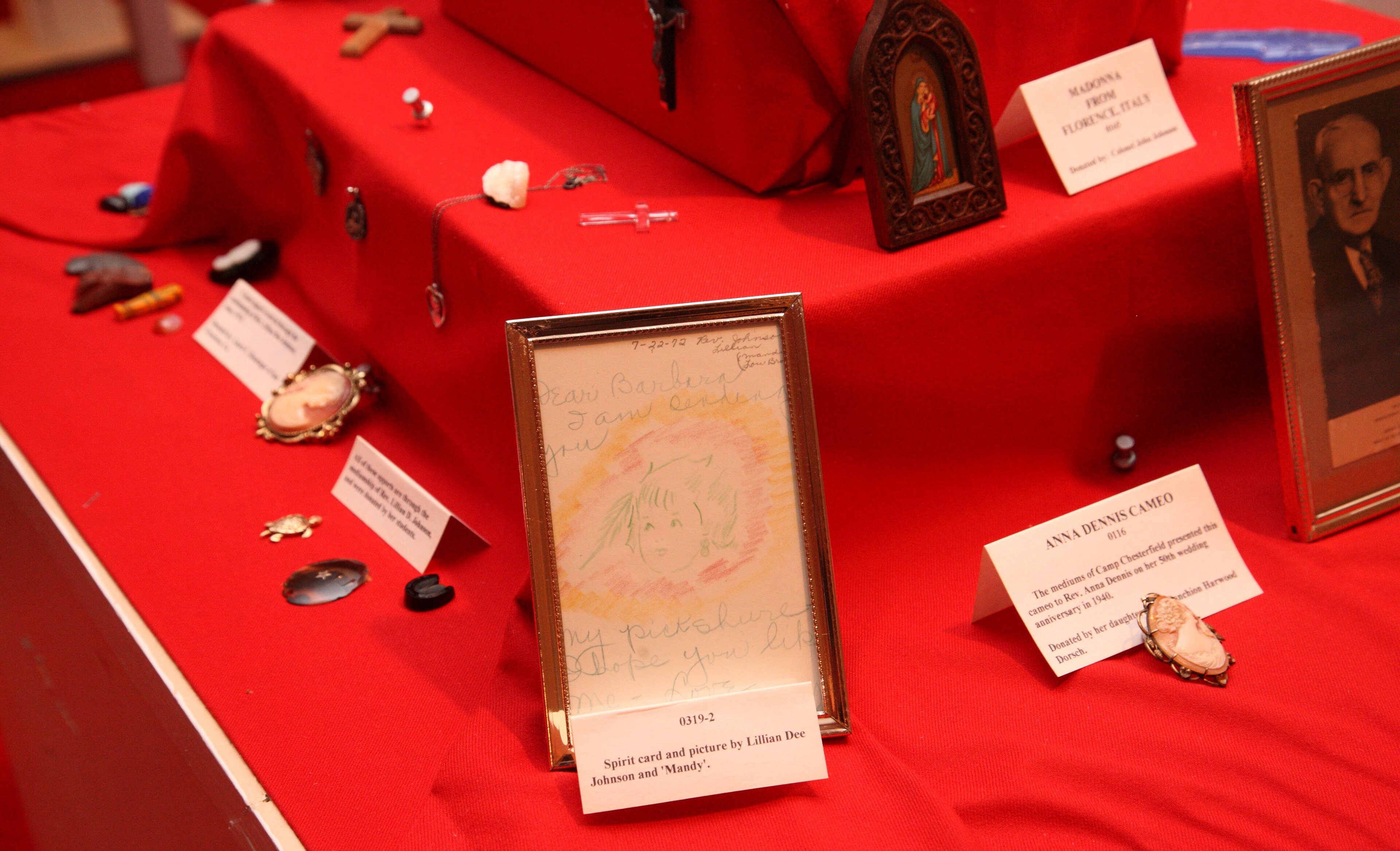 "All of these apports are through the mediumship of Rev. Lillian Dee Johnson, and were donated by her students." 0319-2: Spirit card with drawings by Rev. Lillian Dee Johnson and Mandy, her guide. 0116: Cameo brooch. "Th