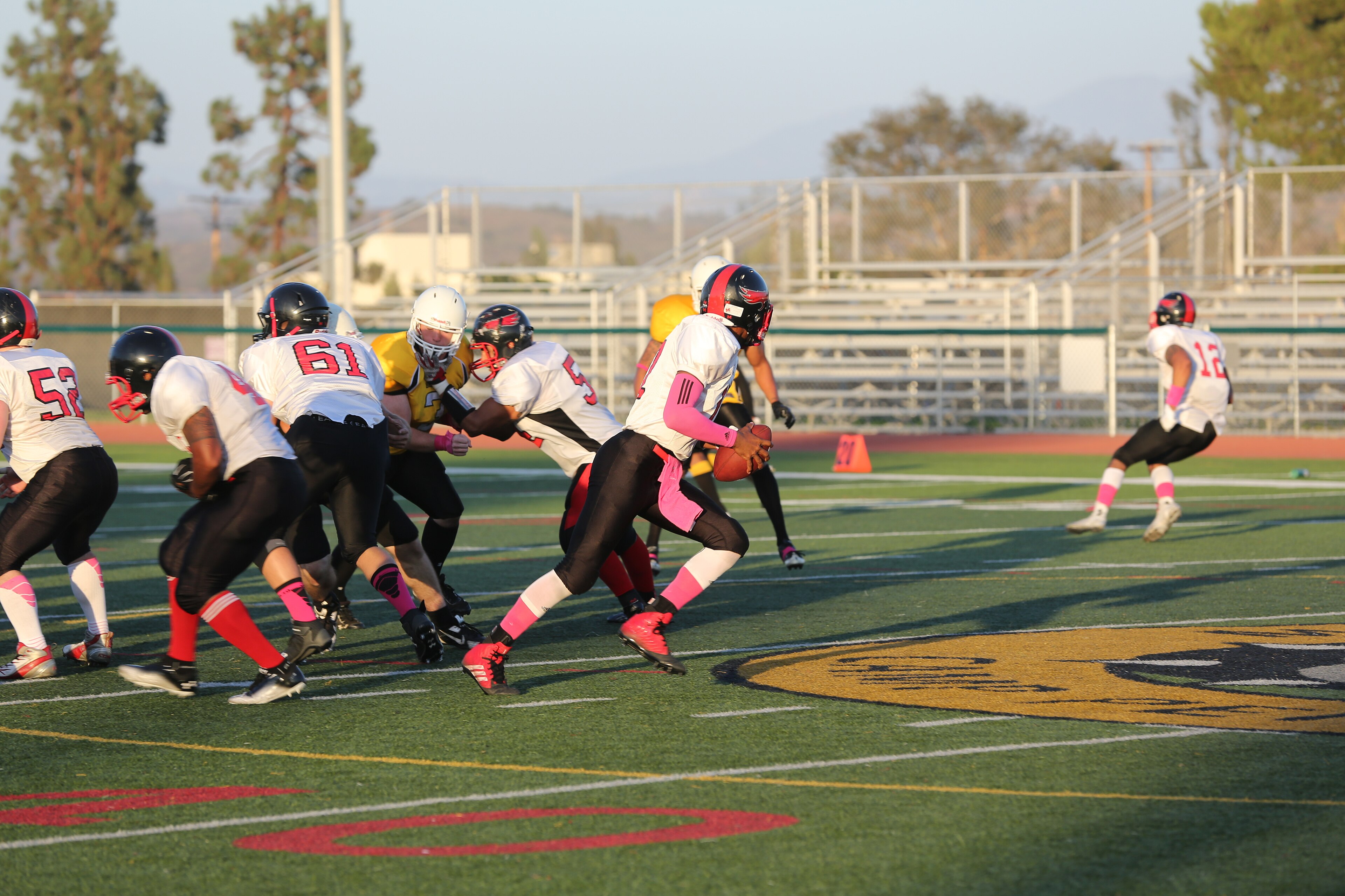 Lance Cpl. Jabari Moore, Marine Corps Air Station Miramar Falcons’ quarterback, rolls out of the pocket during a football game against the 1st Marine Logistics Group Beasts at Paige Fieldhouse aboard Marine Corps Base Ca