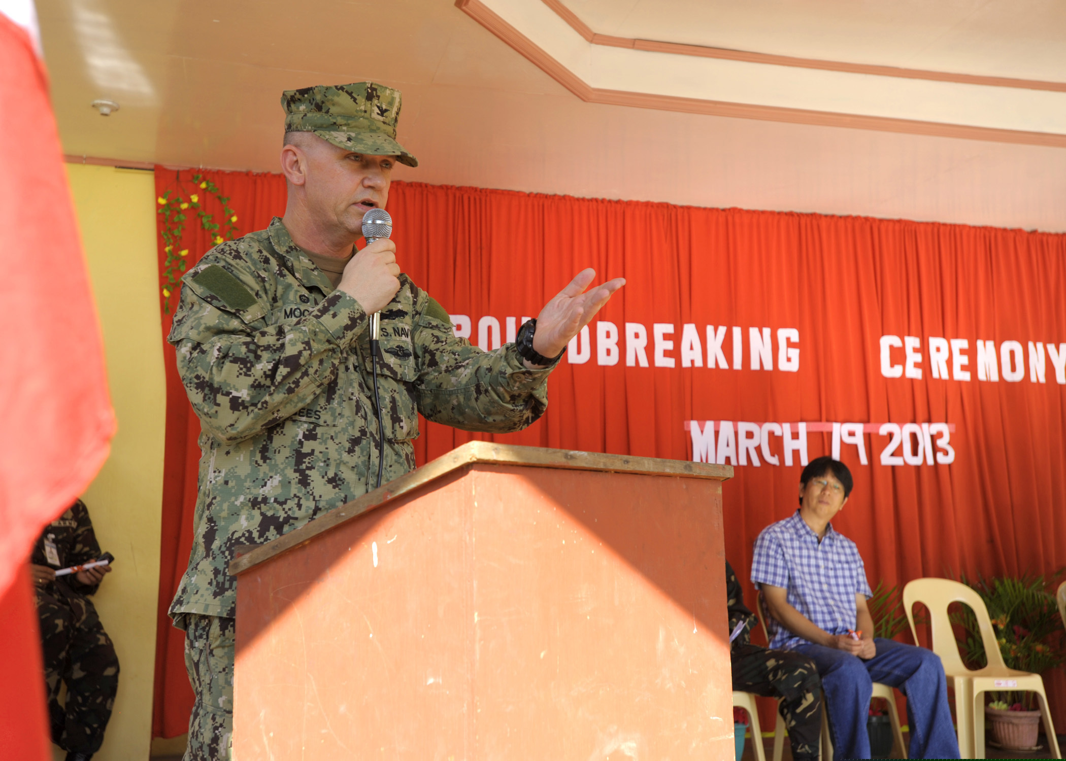 U.S. Navy Capt. Rodney Moore, the co-commander of Joint Civil Military Operations Task Force, addresses local government officials, teachers and students during a groundbreaking ceremony at Omaya Elementary School March 