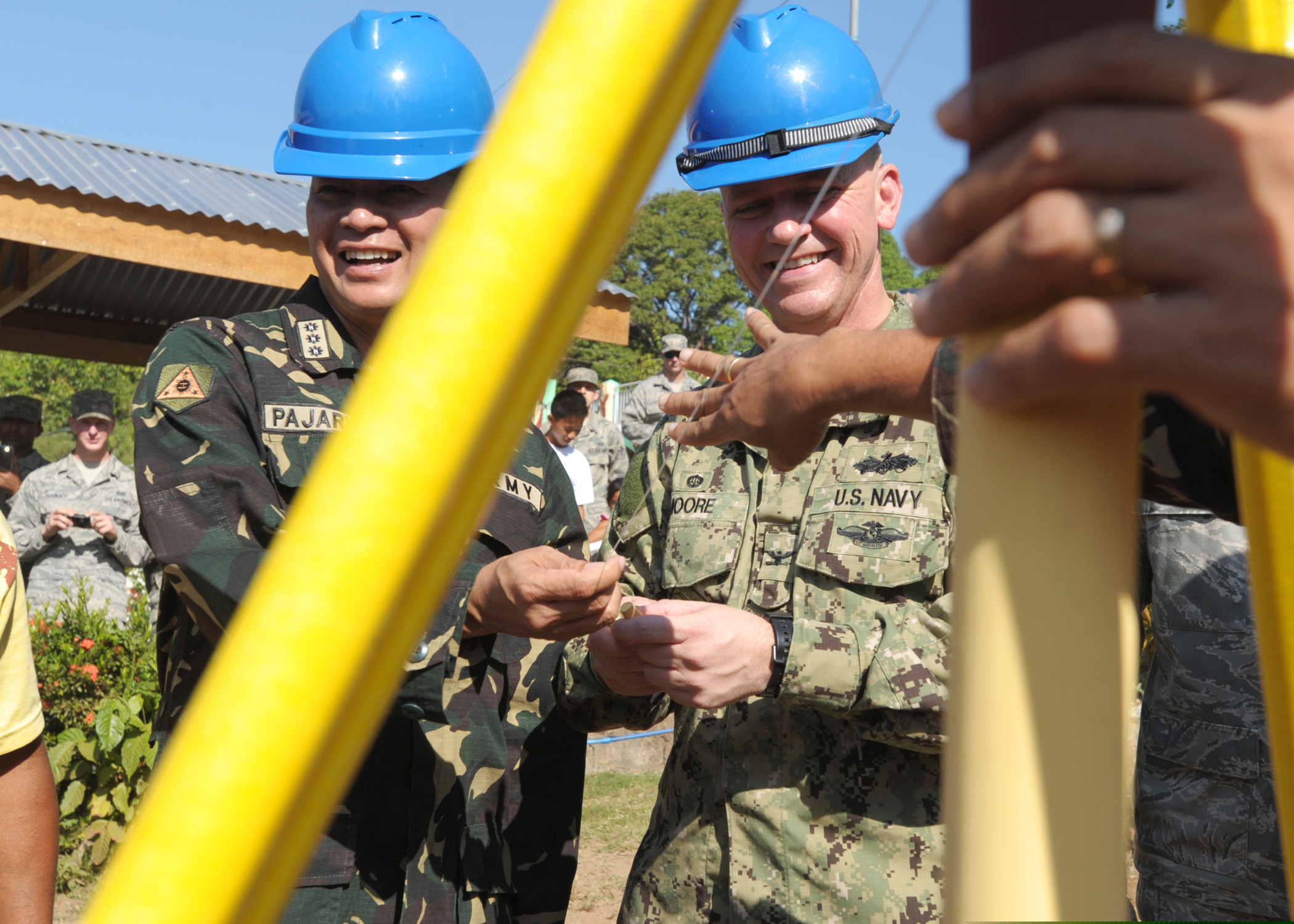 Philippine army Col. Arnulfo R. Pajarillo, left, and U.S. Navy Capt. Rodney Moore, the commanders of Joint Civil Military Operations Task Force, prepare to bury a time capsule during a groundbreaking ceremony at Omaya El