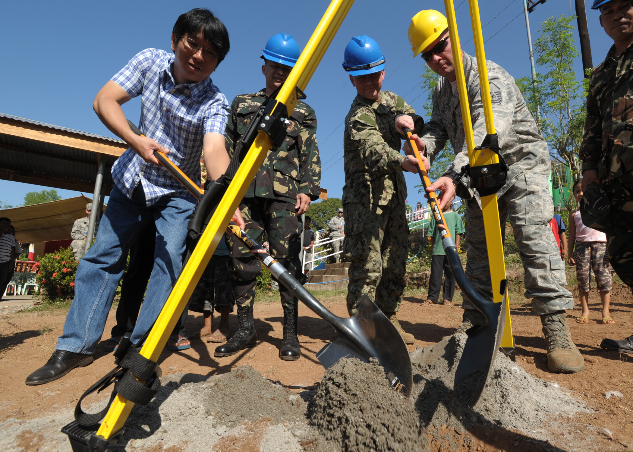 From left, San Narciso Municipality Mayor Peter Lim, Philippine army Col. Arnulfo R. Pajarillo, U.S. Navy Capt. Rodney Moore and Air Force Master Sgt. Benjamin Bone bury a time capsule during a groundbreaking ceremony at