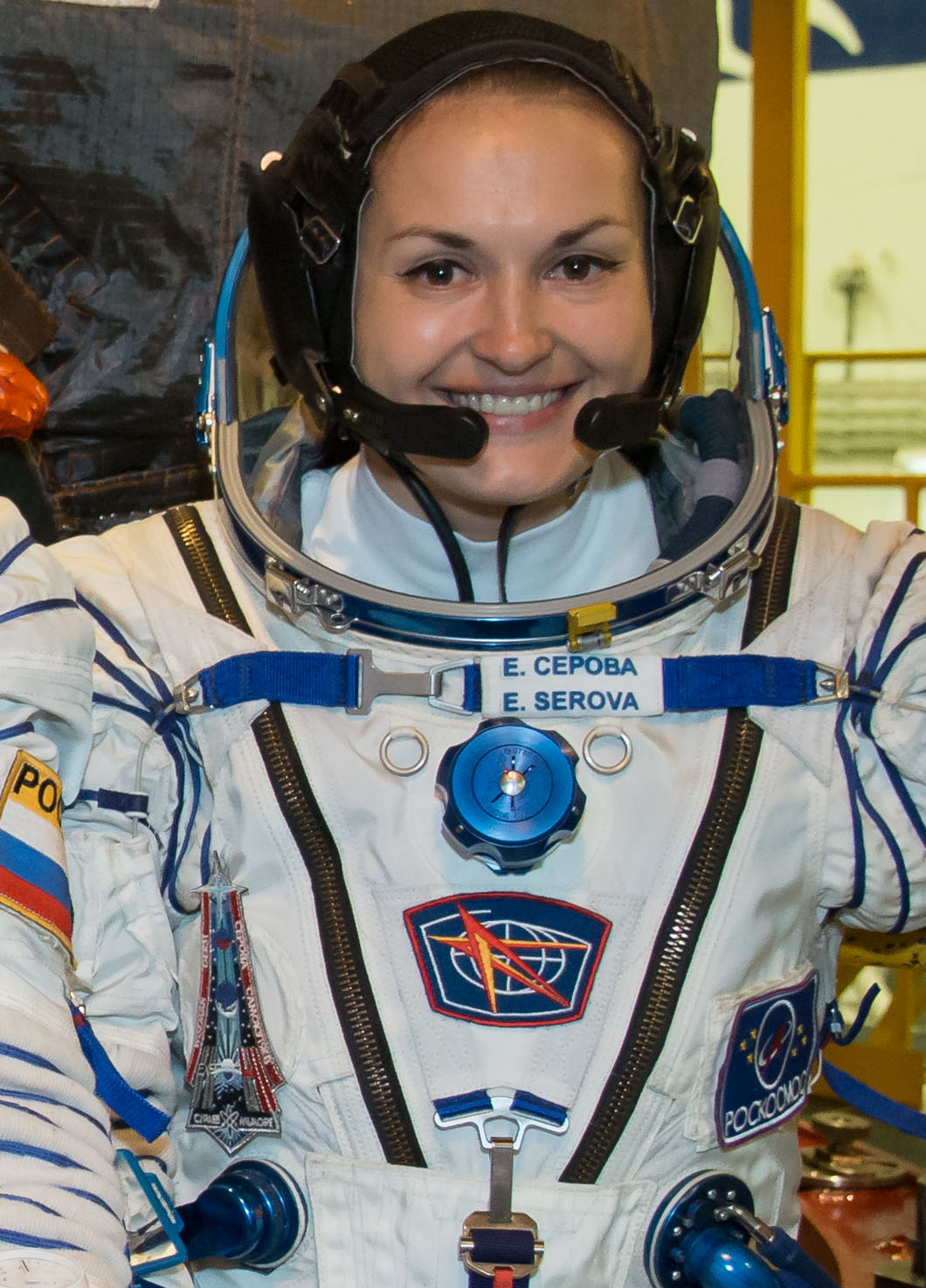 Flight Engineer Elena Serova of Roscosmos pose for pictures Sept. 13 in front of Soyuz TMA-14M spacecraft during the first of two "fit check" dress rehearsal activities